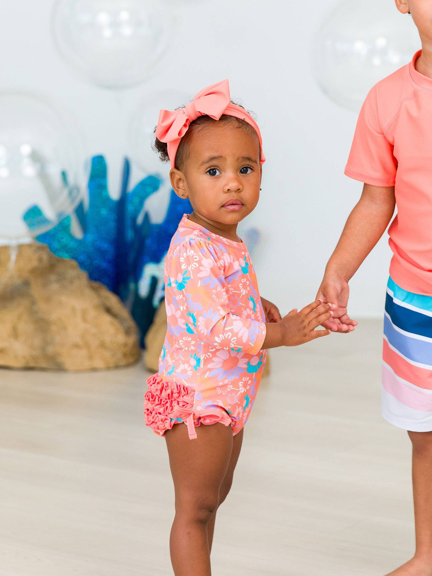 RuffleButts Coral Floral Long Sleeve One Piece Rash Guard